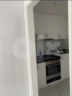 a kitchen with white cabinets and a stove top oven at Apartman 078 in Banja Luka