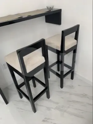 a table and two chairs sitting next to a wall at Apartman 078 in Banja Luka
