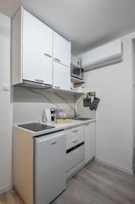 a kitchen with white cabinets and a sink at Apartman LILI centar in Banja Luka