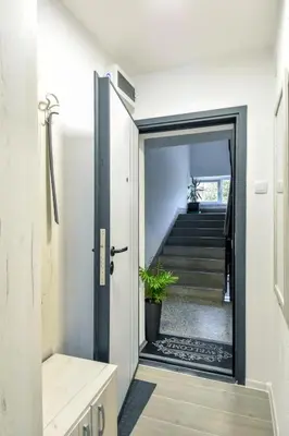 a hallway with a door leading to a staircase at Apartman LILI centar in Banja Luka