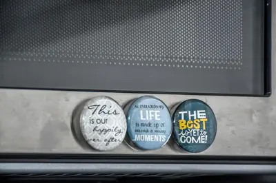 a group of three stickers on the front of a microwave at Apartman LILI centar in Banja Luka