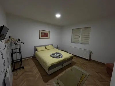 a bedroom with a bed and a television in it at Apartmani Sweet Dreams in Banja Luka