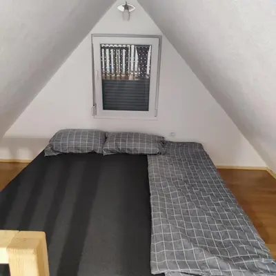 a bed in a room with a window at Vikendica La Anja in Laktaši