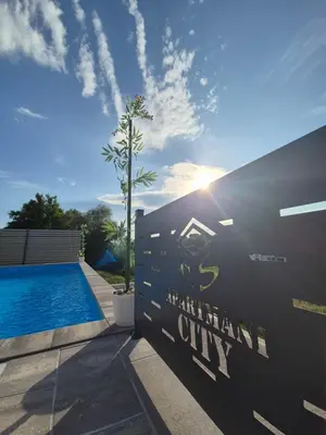 a sign for an american city next to a swimming pool at Apartmani City ES in Cazin