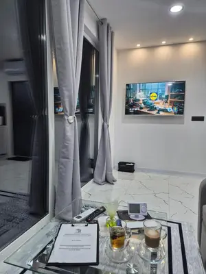 a room with a glass table with two drinks on it at Apartmani City ES in Cazin