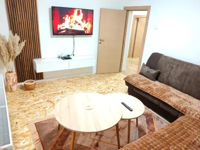 a living room with a couch and a table at Apartman Duric in Tuzla