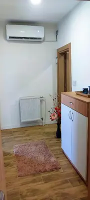 a room with a kitchen with a counter and a refrigerator at Apartman Duric in Tuzla