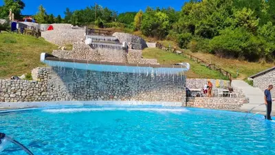 a large pool with a water fountain at Apartman Duric in Tuzla