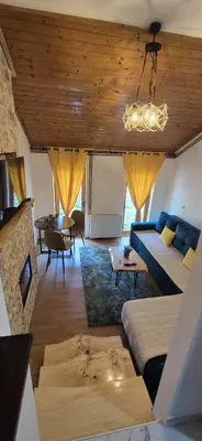 a living room with a blue couch and a table at Viktory in Vlasic