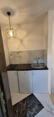 a small kitchen with a sink and a light at Viktory in Vlasic