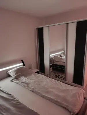 a mirror above a bed in a bedroom at Apartman Ella in Bosanska Krupa