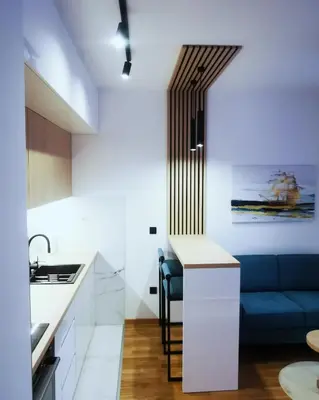 a kitchen and living room with a blue couch at Apartment Shine - Borik in Banja Luka