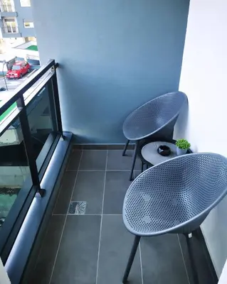 two chairs and a table on a balcony at Apartment Shine - Borik in Banja Luka