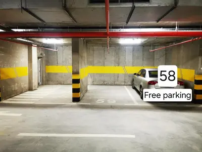 a parking garage with a car parked in it at Apartment Shine - Borik in Banja Luka
