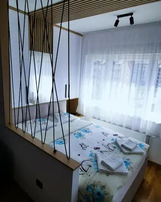 a bedroom with a bed and a window at Apartment Shine - Borik in Banja Luka