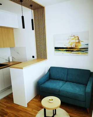 a living room with a blue couch and a table at Apartment Shine - Borik in Banja Luka