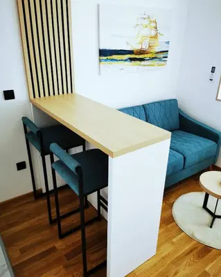 a living room with a table and a blue couch at Apartment Shine - Borik in Banja Luka
