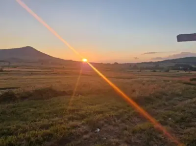 a sunset in the middle of a field at Lukina koliba-vikendica-Manjaca in Banja Luka