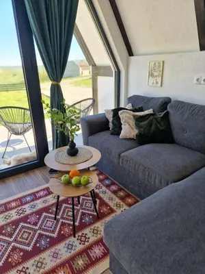 a living room with a couch and a table with fruit on it at Lukina koliba-vikendica-Manjaca in Banja Luka