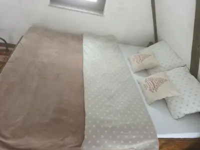 a bed with two pillows and a blanket on it at Lukina koliba-vikendica-Manjaca in Banja Luka