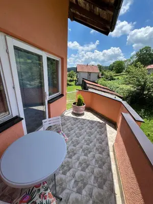 a white table sitting on a patio with a table at La Simba2 in Banja Luka