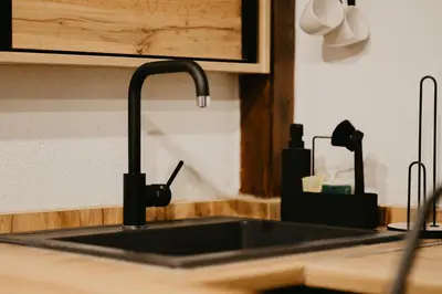 a kitchen counter with a sink in a kitchen at Zapato Apartment Tuzla in Tuzla