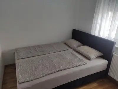 a bed with two pillows on it in a room at Apartman Luka in Doboj