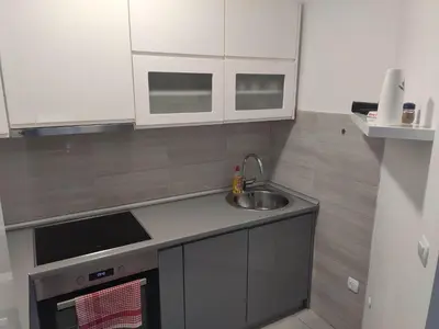 a kitchen with a sink and a counter top at Apartman Luka in Doboj