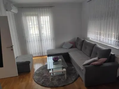 a living room with a couch and a table at Apartman Luka in Doboj