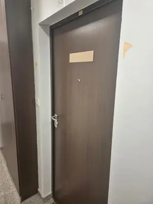 a wooden door in a room with a doorframe at Apartmans Zenica in Zenica