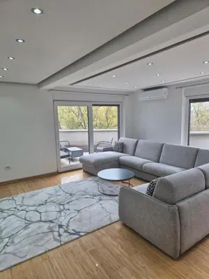 a living room with a couch and a table at Apartmans Zenica in Zenica