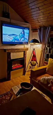 a living room with a fireplace with a flat screen tv at Viktory II in Vlasic