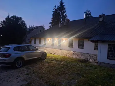 a car parked in front of a house at night at Viktory II in Vlasic