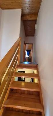a staircase in a house with wooden ceilings at Viktory II in Vlasic