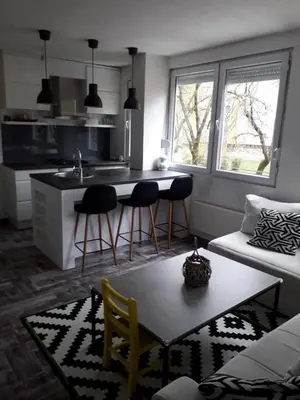 a kitchen and living room with a table and chairs at Centar in Banja Luka