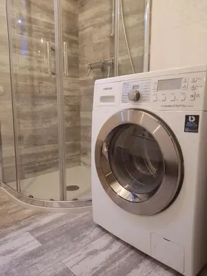 a washing machine in a bathroom with a shower at Centar in Banja Luka
