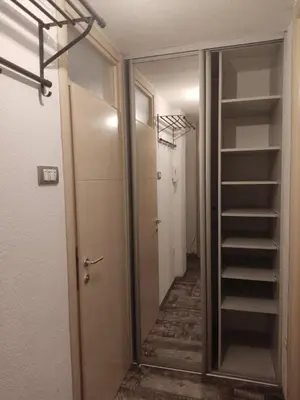 a hallway with a mirror and a walk in closet at Centar in Banja Luka