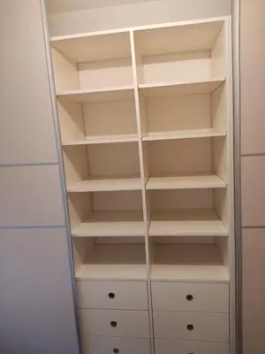 a closet with white shelves and white cabinets at Centar in Banja Luka