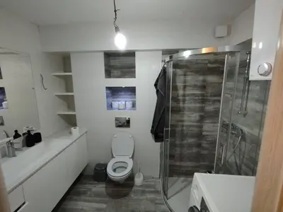 a white bathroom with a toilet and a shower at Centar in Banja Luka