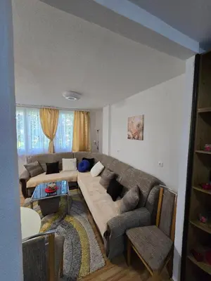 a living room with a couch and a table at Apartman Lea in Železnička Stanica Incel
