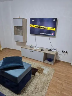 a living room with a flat screen tv on a wall at Apartman Lea in Železnička Stanica Incel