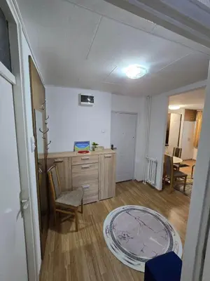 a room with a desk and a chair and a table at Apartman Lea in Železnička Stanica Incel