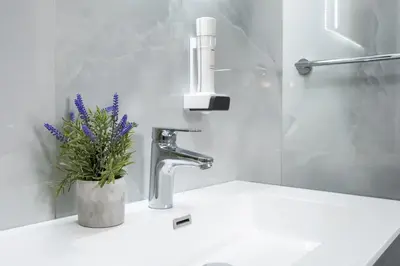 a bathroom sink with a faucet with a plant on it at Motel Jelić in Kraševo