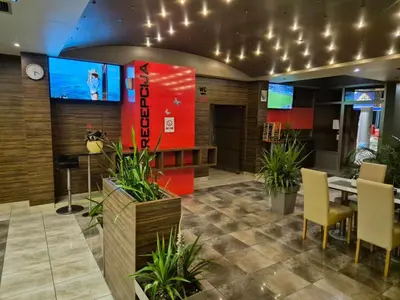 a lobby with a table and chairs and a tv at Motel Jelić in Kraševo