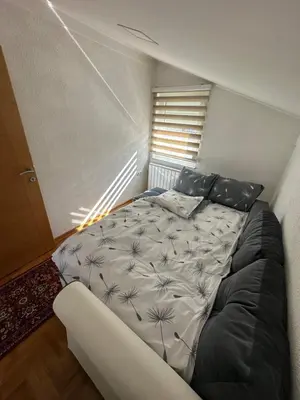 a bedroom with a large bed in a room at Visoko City Apartment in Visoko