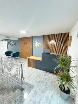 a lobby with a potted plant in a building at Apartmani Ikanović in Cazin