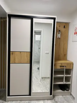 a bathroom with a glass door with a mirror at Apartmani Ikanović in Cazin