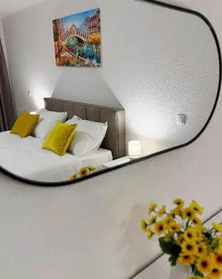 a reflection of a bed in a mirror at Apartmani Ikanović in Cazin
