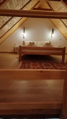 a bed in the attic of a room at Koliba Brezova šuma in Čović Polje