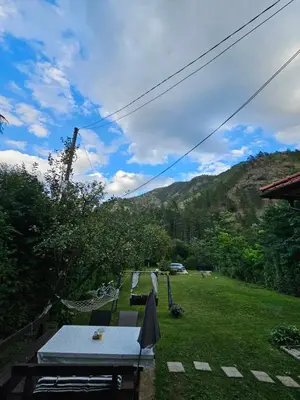 a picnic table in a yard with a view of a mountain at Vikendica Šehić in Zavidovići